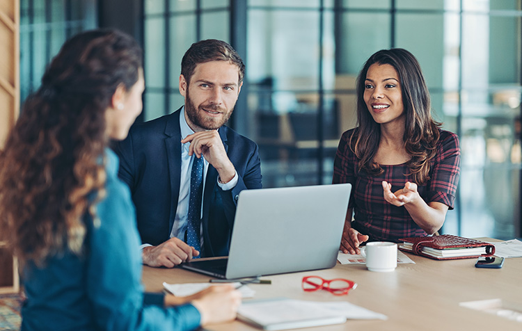 A group of three colleagues at a meeting